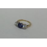 An attractive sapphire and diamond three stone rin