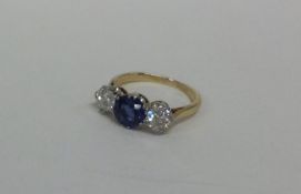 An attractive sapphire and diamond three stone rin