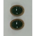 A pair of 14 carat gold green stone hoop earrings