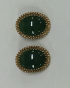 A pair of 14 carat gold green stone hoop earrings