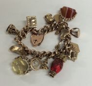 A heavy 9 carat multi charm bracelet with heart sh