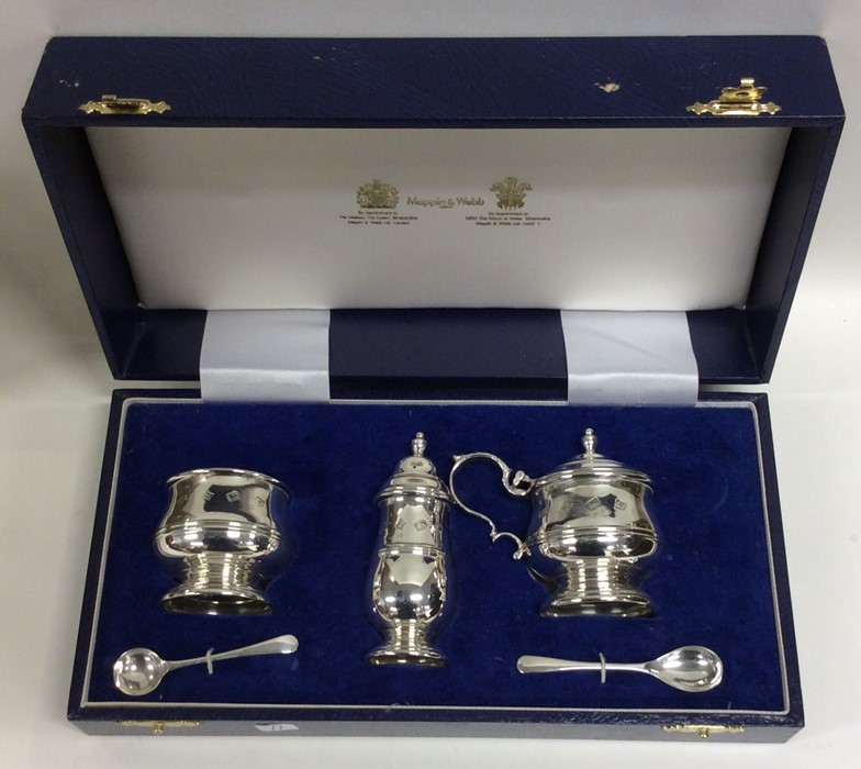 A cased silver three piece cruet contained within