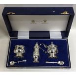 A cased silver three piece cruet contained within
