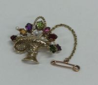 A 9 carat brooch in the form of a basket of flower