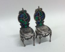 A pair of plique-à-jour silver miniature chairs wi