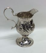 A good Georgian silver cream jug with embossed dec