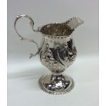 A good Georgian silver cream jug with embossed dec