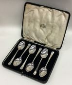 A boxed set of heavy silver teaspoons of plain tap