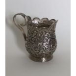 A heavy Indian silver cream jug with scroll and le