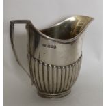 A silver half fluted silver cream jug. Sheffield.