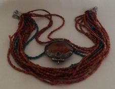 An unusual silver, amber and coral mounted necklac
