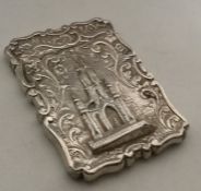 A silver card case with Scott Memorial in relief.