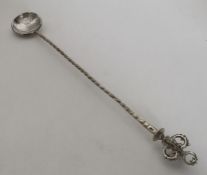 A large Continental silver spoon with swirl handle