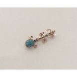 A stylish turquoise brooch with scroll mounts. App