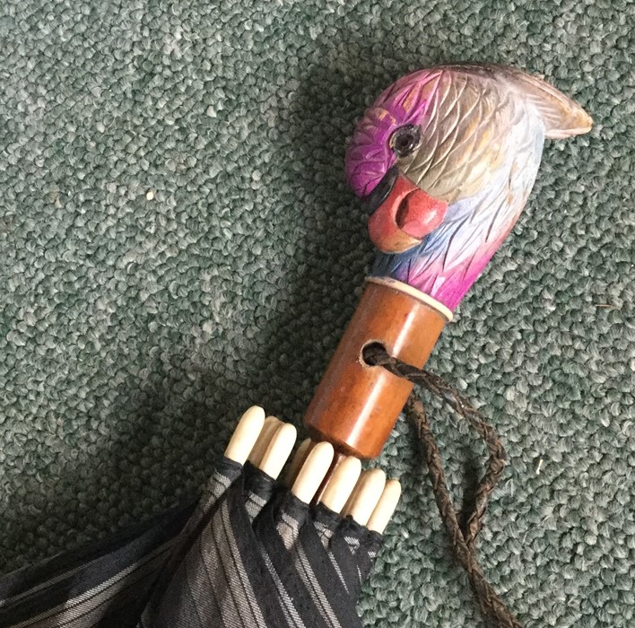 An unusual umbrella in the form of a parrot. Est.