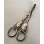 A pair of Edwardian silver grape scissors with scr