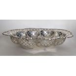 An Edwardian silver bread basket with pierced moun