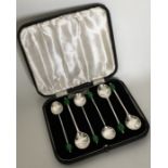 A boxed set of six silver bean top coffee spoons.