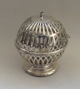 An unusual silver string holder of ball form with