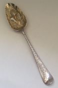 A Georgian silver bright cut berry spoon with gilt