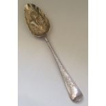 A Georgian silver bright cut berry spoon with gilt