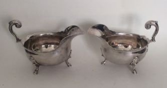 A pair of George II heavy silver sauce boats with