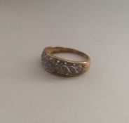 A 9 carat diamond cluster ring of wavy design. App