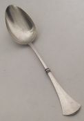 A Russian silver tablespoon with tapering handle.
