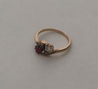A ruby and diamond eight stone crossover ring in g
