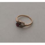 A ruby and diamond eight stone crossover ring in g