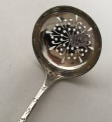 An Edwardian silver engraved sifter spoon with pie