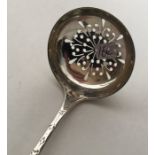 An Edwardian silver engraved sifter spoon with pie
