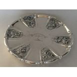 A large circular silver teapot stand attractively