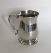 A Georgian silver baluster shaped mug on spreading