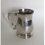 A Georgian silver baluster shaped mug on spreading
