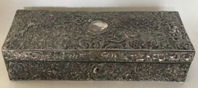 A large silver embossed jewellery case decorated w