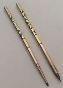 A stylish and rare pair of enamelled pens decorate