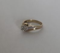 A 9 carat diamond two colour gold crossover ring i