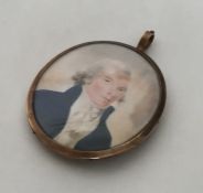 An oval gold miniature depicting a gentleman of ti