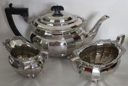 A heavy silver panelled three piece tea service. B