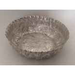 A Turkish circular silver dish with floral decorat