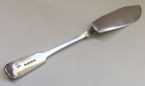 A fiddle pattern silver butter knife. London. By G