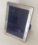 A modern silver rectangular picture frame with vel