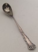 An American silver gilt preserve spoon with scroll