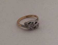An 18 carat heart shaped diamond three stone ring.