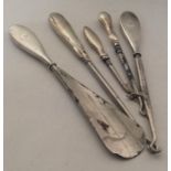 A group of silver mounted button hooks and shoe ho