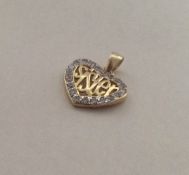 A small silver gilt heart shaped pendant with the