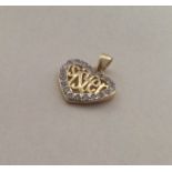 A small silver gilt heart shaped pendant with the