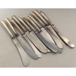 A group of silver mounted tea knives with steel bl
