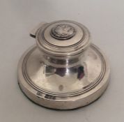 A circular silver capstan shaped inkwell. Chester.